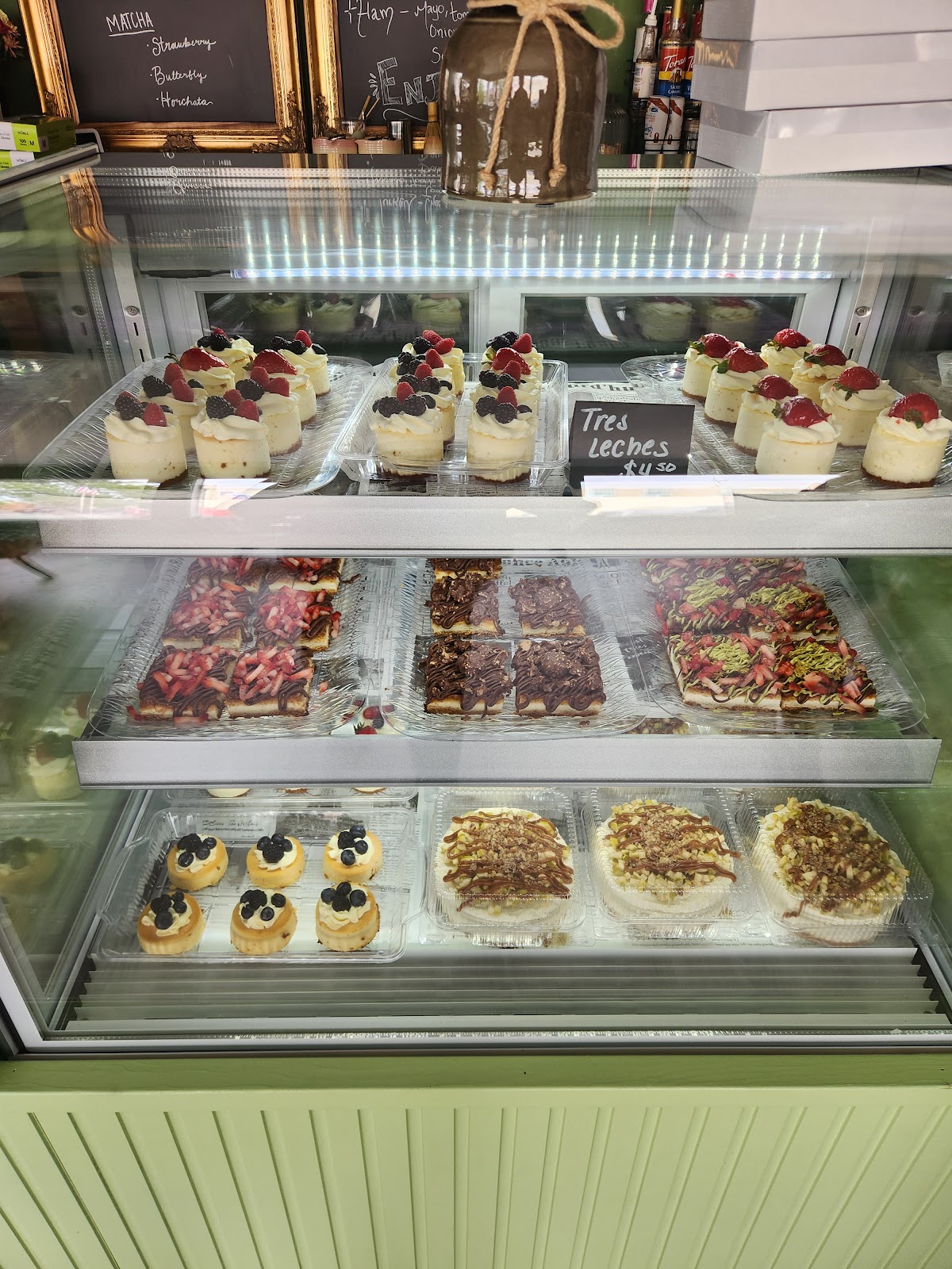 A bakery case of tres leches, fruit-topped cheesecakes and fresh tarts